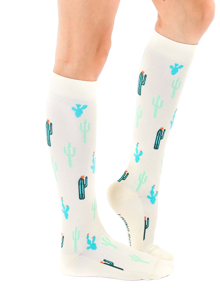 Lifestyle shot of a person wearing the Cactus Knee-High Socks, showcasing how they look when worn. [lf]