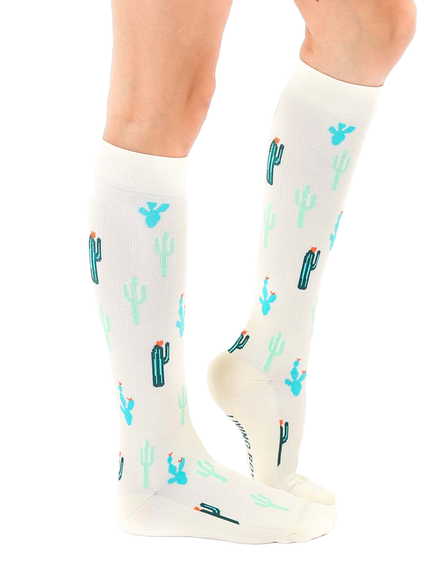 Lifestyle shot of a person wearing the Cactus Knee-High Socks, showcasing how they look when worn. [lf]
