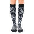 Pair of black knee-high socks with a silver paisley pattern.  The socks are shown from the front on a white background. [lf]