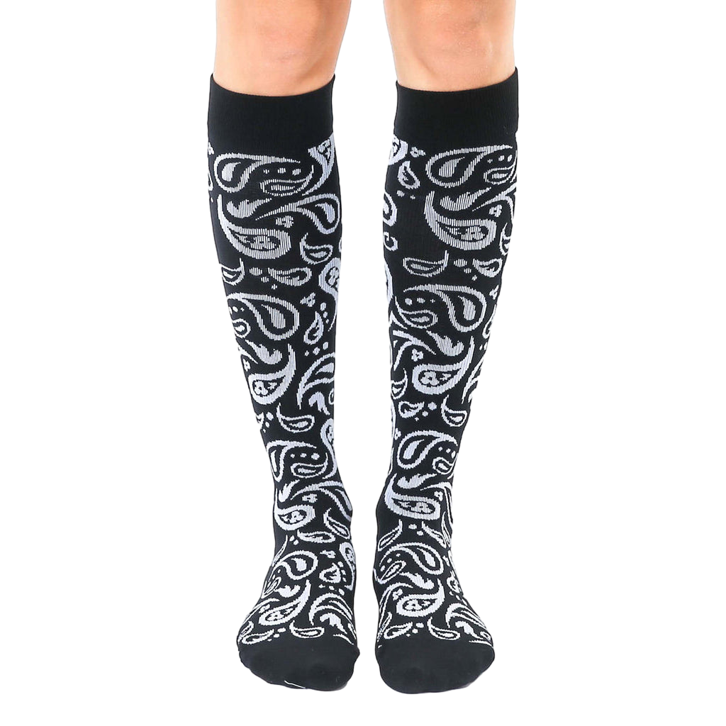 Pair of black knee-high socks with a silver paisley pattern.  The socks are shown from the front on a white background. [lf]