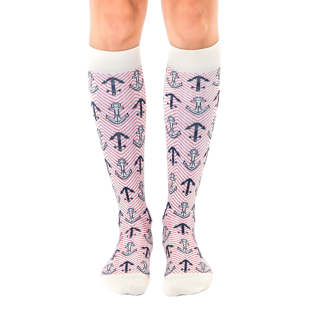 Pair of women's knee-high socks in white with a red and navy anchor and herringbone pattern. [lf]
