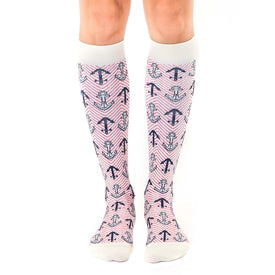 women's knee-high white socks adorned with red diagonal lines and dark blue anchors, embodying the maritime theme.  