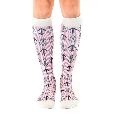 women's knee-high white socks adorned with red diagonal lines and dark blue anchors, embodying the maritime theme.  