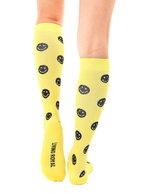 Close-up of the back of the yellow smiley face knee-high socks, showcasing the 'Living Royal' logo. [lf]
