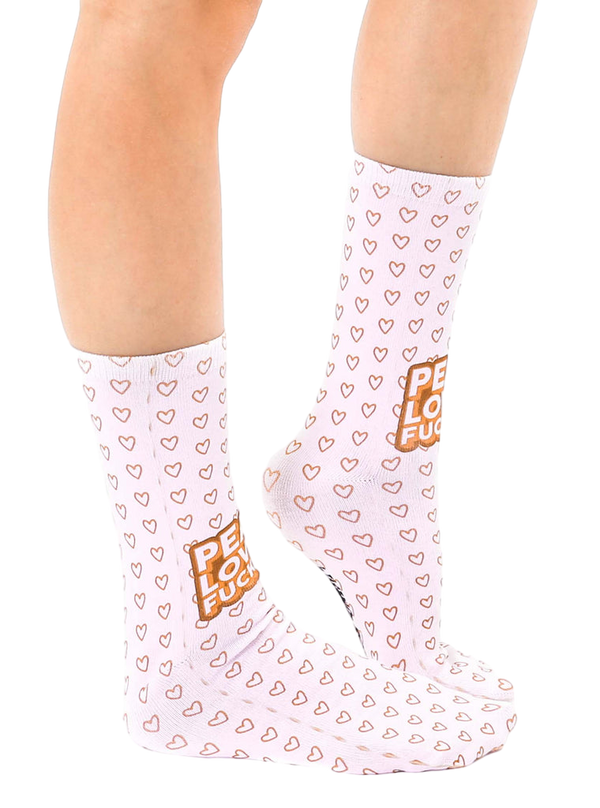 Lifestyle shot of a person's legs wearing the 'Peace Love' socks. Socks are shown from the side, highlighting their full length. [lf]