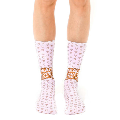 pink and brown heart pattern socks with "peace love fuck you" in brown letters. unisex crew socks.   