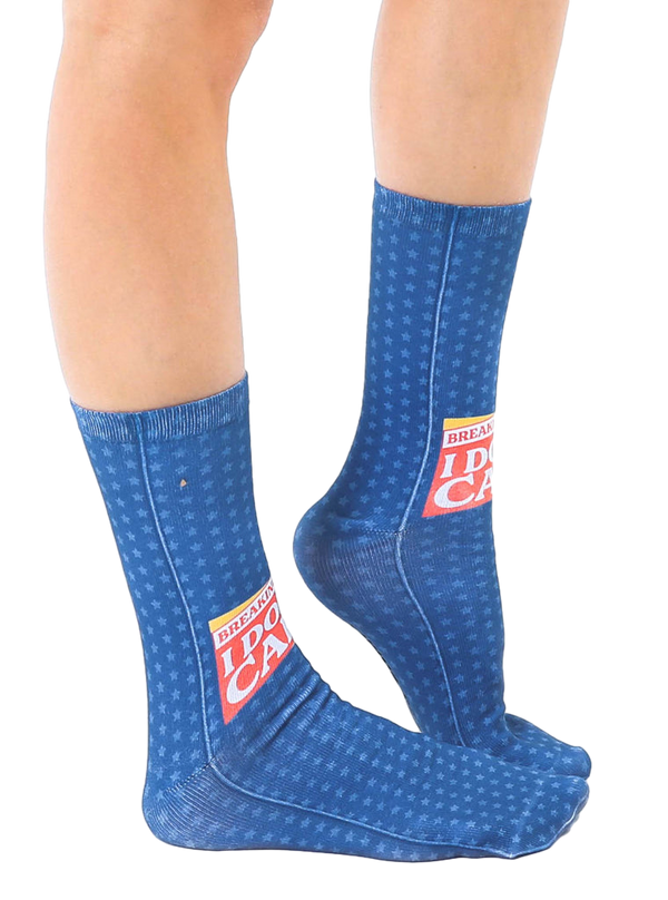 Lifestyle shot showing the 'Breaking News: I Don't Care' socks on a person's feet, showcasing the fit and design on a leg. [lf]