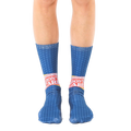 A pair of blue crew socks with a repeating star pattern and a bold 'Breaking News: I Don't Care' graphic in red and yellow. [lf]