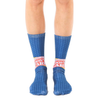 A pair of blue crew socks with a repeating star pattern and a bold 'Breaking News: I Don't Care' graphic in red and yellow. [lf]