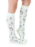 Lifestyle shot of a person wearing a mint green Pulse sock. Shows the sock's length and design on the leg. [lf]