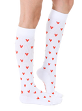 Lifestyle shot of a person's legs wearing the white knee-high socks with red hearts. [lf]