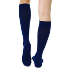Flat lay arrangement showing the full length and clean design of the solid color knee-high socks.