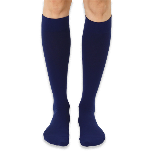 Front view of solid navy blue knee-high socks worn on legs against a dark background.