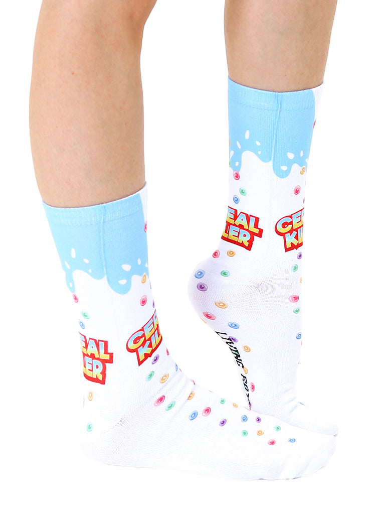 Lifestyle shot of a person's legs wearing the Cereal Killer socks.  Shows the socks on a foot and lower leg. [lf]