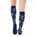Back view of legs wearing navy blue knee-high socks showing the light blue mushroom and green leaf patterns on the calves.