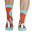 Pair of fox slipper socks on a person's legs. 