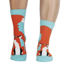 Pair of fox slipper socks on a person's legs. 