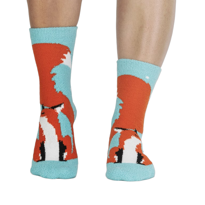 Pair of fox slipper socks on a person's legs. 
