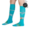 Lifestyle shot of model wearing 'Plays Well With Otters' knee-high socks, showcasing the fun, whimsical design.