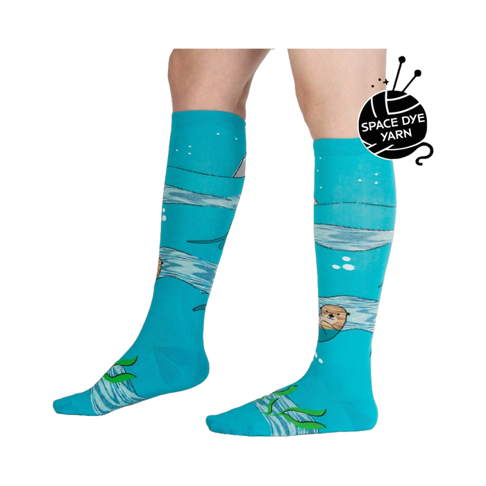 Lifestyle shot of model wearing 'Plays Well With Otters' knee-high socks, showcasing the fun, whimsical design.
