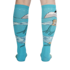 Back view of the 'Plays Well With Otters' knee-high socks highlighting the full design, including the otters and icebergs.