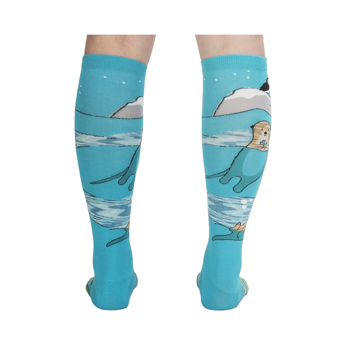 Back view of the 'Plays Well With Otters' knee-high socks highlighting the full design, including the otters and icebergs.