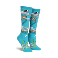 Pair of teal knee-high socks featuring otters, puffins, and icebergs.  Space dye yarn creates a whimsical, underwater scene.