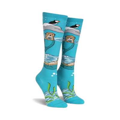 knee high blue novelty sock with otter, pufin, and seaweed pattern. cute and cozy for movie marathons or an ocean getaway.   