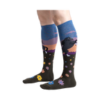 Lifestyle shot: Model wearing a pair of 'Black Beauty' knee-high socks, showing the design and fit.