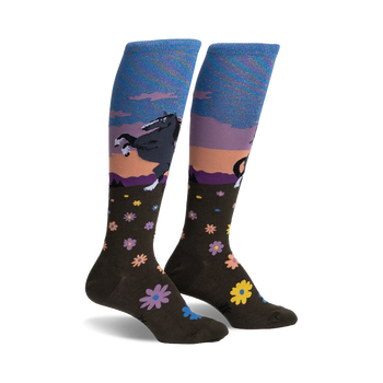 dark brown floral pattern knee-high socks for women feature a leaping black horse against a sunset background. horse-themed socks.  
