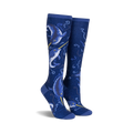 Pair of knee-high socks in navy blue.  Features a whimsical design of narwhals and swirling ocean patterns with subtle shimmer.
