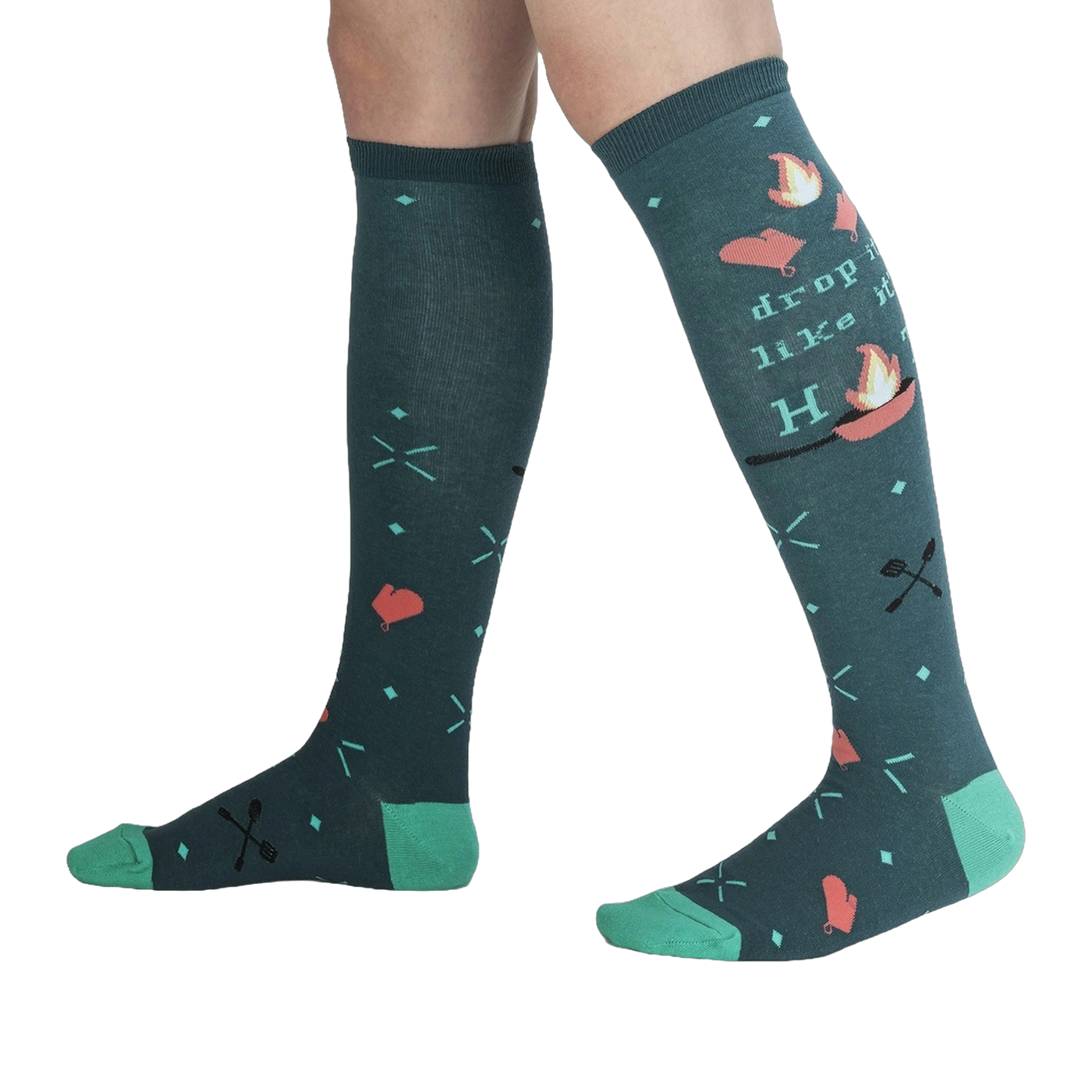 Lifestyle shot showing the 'Drop It Like It's Hot' socks on a person's legs.  The teal and green colors pop against the dark background.
