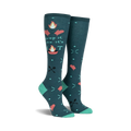 Pair of teal knee-high socks with a 'Drop It Like It's Hot' design. Campfire graphics, flaming hearts, and crossed utensils are featured on a teal background.
