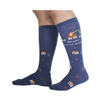 Lifestyle shot of 'Bless This Mess' socks on a person's legs, showcasing the sock's length and design.