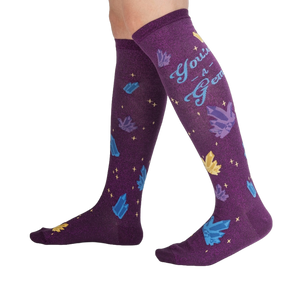 Lifestyle shot showcasing the 'You're a Gem' knee-high socks on a person's legs, showing off the design and fit.