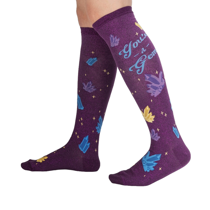 Lifestyle shot showcasing the 'You're a Gem' knee-high socks on a person's legs, showing off the design and fit.