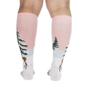 Back view of model wearing pink and white knee-high socks with a winter scene.