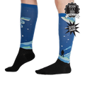 Lifestyle shot of the Northern Lights glow-in-the-dark socks on a model's legs, showcasing their length and design.