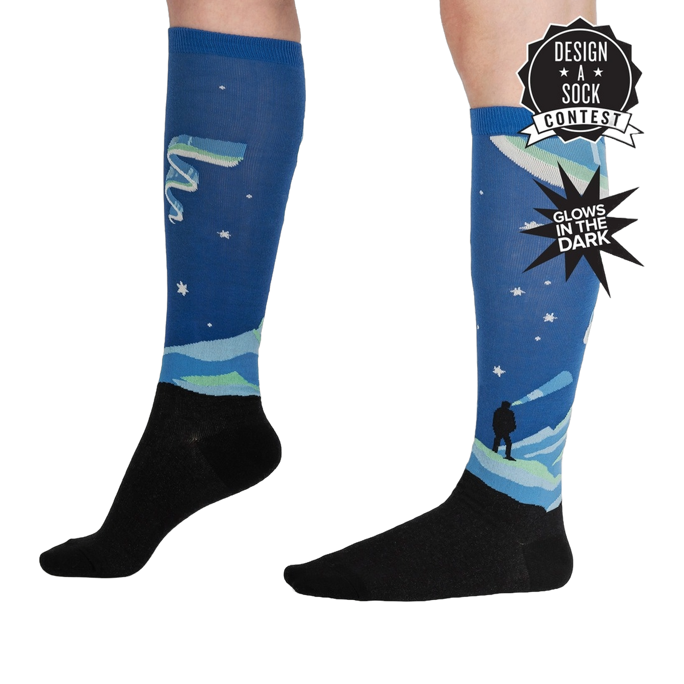 Lifestyle shot of the Northern Lights glow-in-the-dark socks on a model's legs, showcasing their length and design.