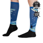 Lifestyle shot of the Northern Lights glow-in-the-dark socks on a model's legs, showcasing their length and design.