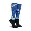 Pair of knee-high socks showcasing a Northern Lights design. Blue, green, and black colors are featured, along with a silhouette of a person watching the lights.