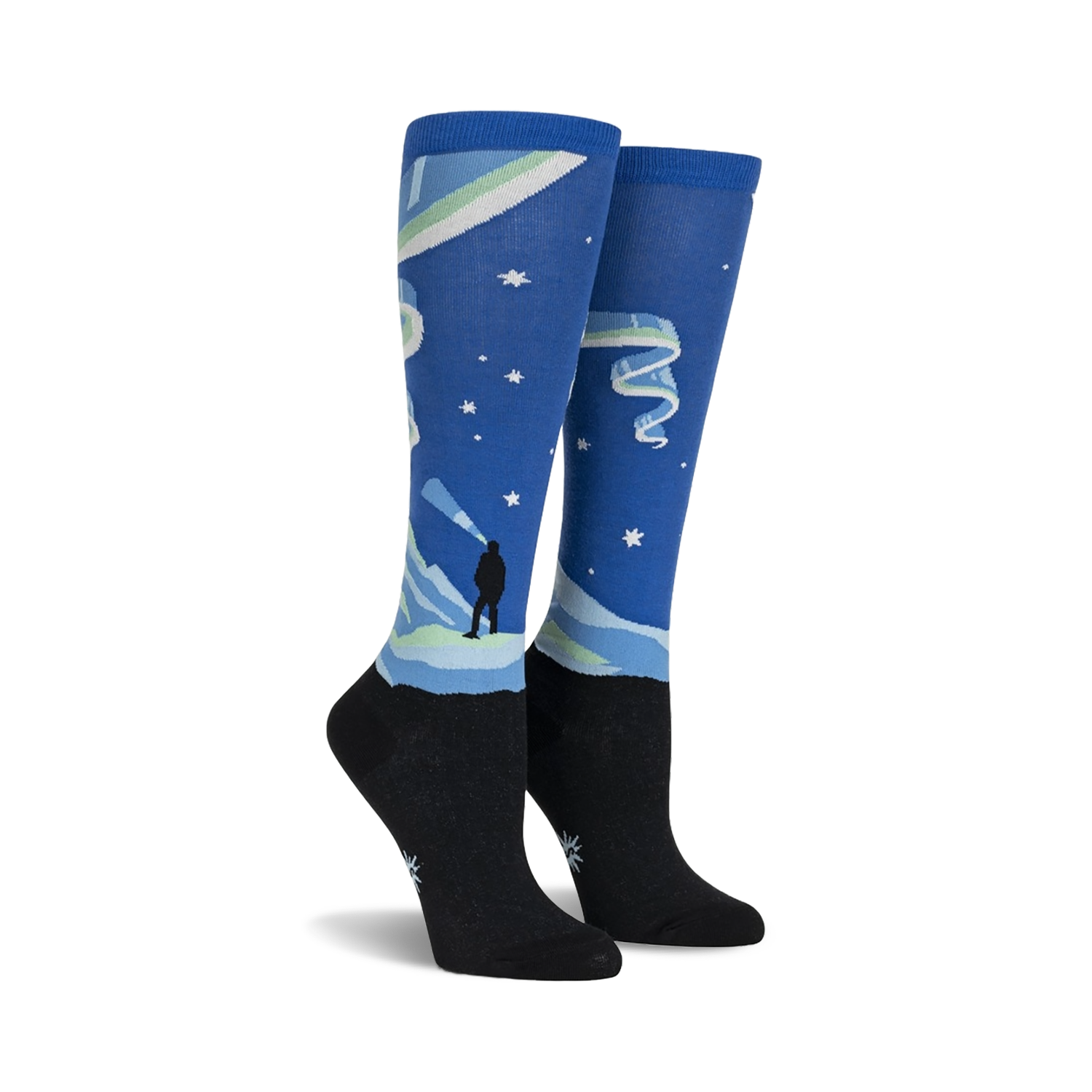 Pair of knee-high socks showcasing a Northern Lights design. Blue, green, and black colors are featured, along with a silhouette of a person watching the lights.