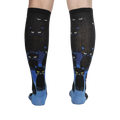 Rear view of the socks on a person's legs, showcasing the full design and cat pattern.