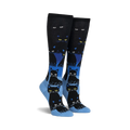Pair of black and blue knee-high socks with a repeating pattern of black cats. The cats glow in the dark, and the socks have a gradient design.