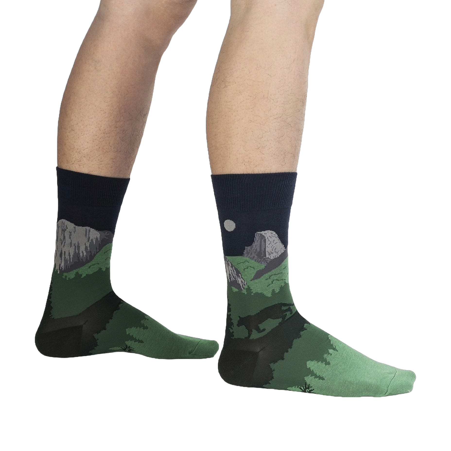 Lifestyle shot of a person wearing the Half Dome Yosemite socks, showcasing the socks' fit and design on the leg against a black background.