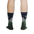 Rear view of the Half Dome Yosemite socks on a person's legs against a black background.  The socks' design is visible from the back.