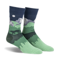Pair of crew socks showcasing a nighttime scene of Half Dome in Yosemite National Park.  Dark green, navy blue, and gray colors depict mountains, trees, and a full moon.