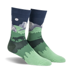 Pair of crew socks showcasing a nighttime scene of Half Dome in Yosemite National Park.  Dark green, navy blue, and gray colors depict mountains, trees, and a full moon.