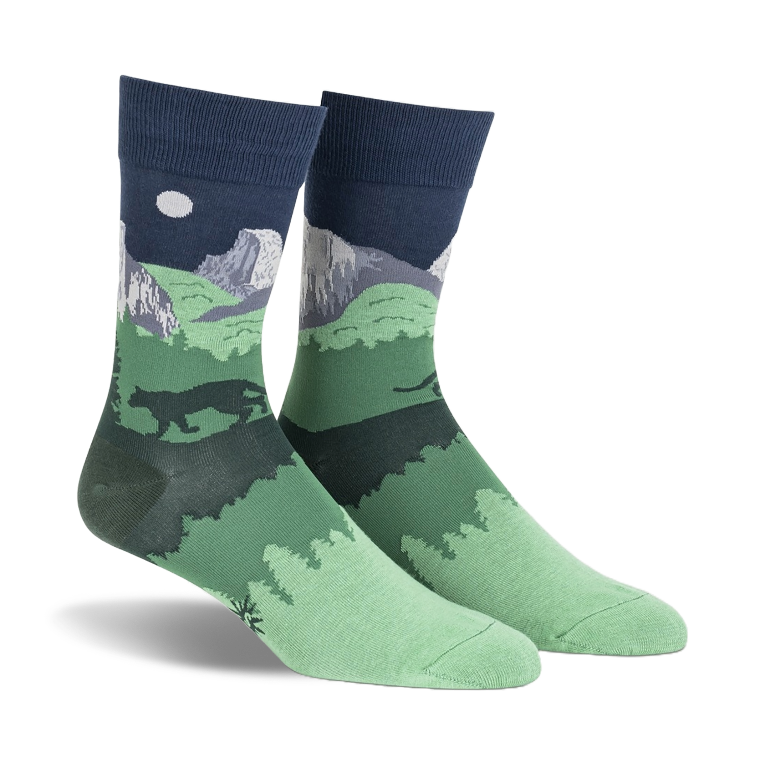 Pair of crew socks showcasing a nighttime scene of Half Dome in Yosemite National Park.  Dark green, navy blue, and gray colors depict mountains, trees, and a full moon.