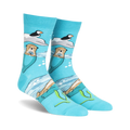 Crew socks in teal featuring otters holding flowers, puffins on ice floes, and an ocean scene. Made with space dye yarn.